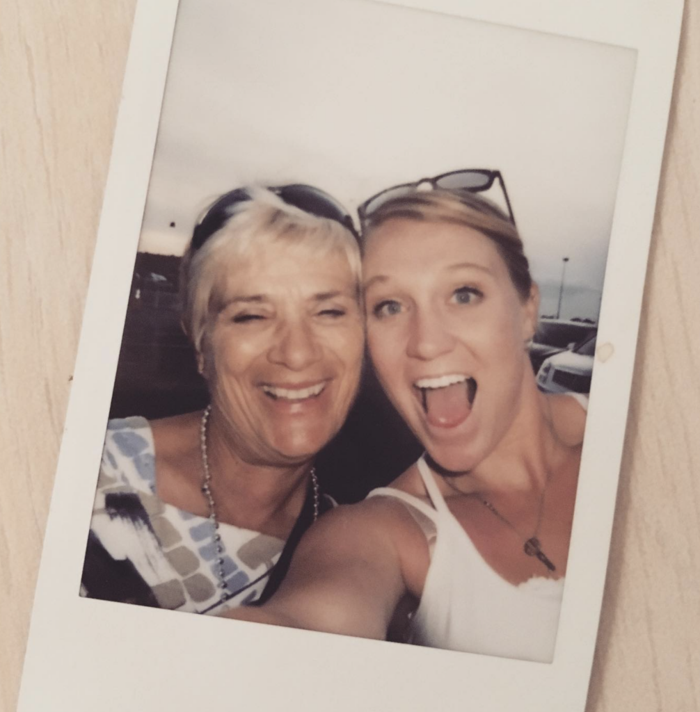 two blonde women smiling and hugging